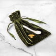 Load image into Gallery viewer, Caviar gift set with emerald velvet bad under tin opener, mother-of-pearl-spoon on a marble background