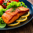 Load image into Gallery viewer, Sliced gravadlax salmon with fresh dill on dark rye bread served on a wooden cutting board with dill sauce
