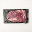 Load image into Gallery viewer, Vacuum-sealed package of Grass Fed Australian Wagyu Ribeye MS 8-9 on a white background

