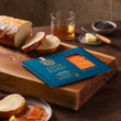 Load image into Gallery viewer, Loch Duart Double Smoked Salmon package on a wooden cutting board with sliced sourdough bread, whisky, butter, and peppercorns
