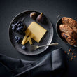 Load image into Gallery viewer, Platter with cheese, figs, blueberries, and bread on a dark surface
