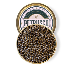 Petrusco Caviar gold and emerald tin partially hidden behind the full circle open tin of caviar displaying the fresh sturgeon roe 