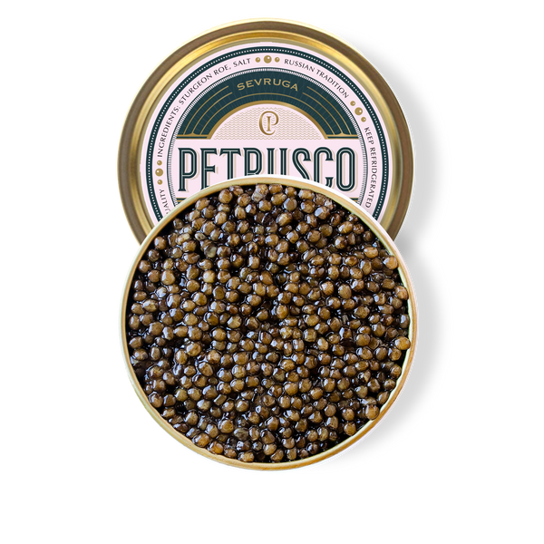 Petrusco Caviar gold and emerald tin partially hidden behind the full circle open tin of caviar displaying the fresh sturgeon roe