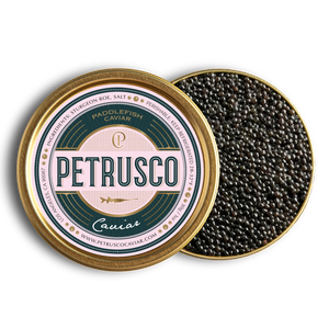 Petrusco Caviar Paddlefish spoonbill roe displayed in gold and emerald tin with a label partially covering caviar