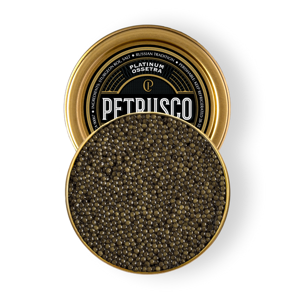 Open tin of Petrusco Platinum Ossetra caviar showing glossy dark olive pearls on a white background.