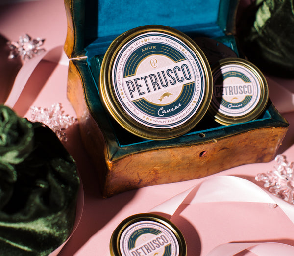 Petrusco Caviar displayed in wooden chest with amur and river beluga sturgeon roe sitting side-by-side